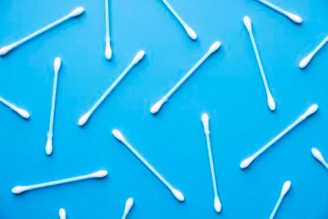 Flat lay composition with cotton swabs on blue background. Top view ear sticks Stock Photos