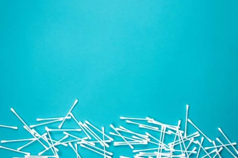 Flat lay composition with cotton swabs on blue background. Top view ear stick Stock Photos