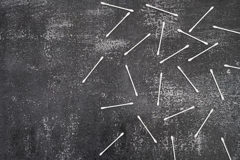 Flat lay composition with cotton swabs on gray background. Top view ear sticks Stock Photos