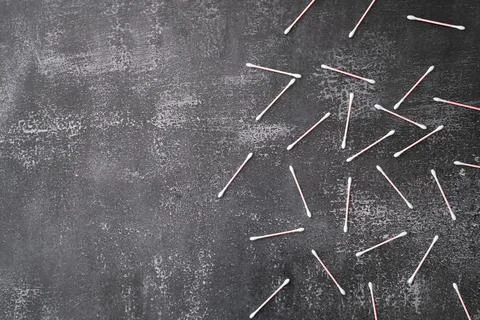 Flat lay composition with cotton swabs on gray background. Top view ear sticks Stock Photos