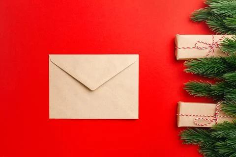 Flat lay composition of craft paper envelope on red isolated background with Stock Photos