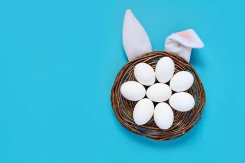 Flat lay composition of creative Easter bunny ears on blue background, space for Photos