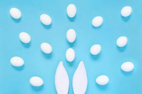 Flat lay composition of creative Easter bunny ears on blue background, space  写真素材