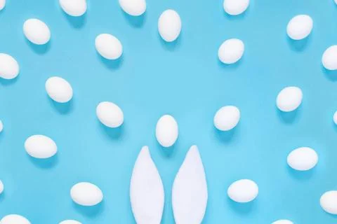 Flat lay composition of creative Easter bunny ears on blue background, space  写真素材