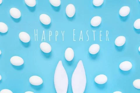 Flat lay composition of creative Easter bunny ears on blue background, space  写真素材