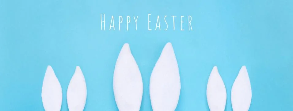 Flat lay composition of creative Easter bunny ears on blue background, space  Stockfoto's