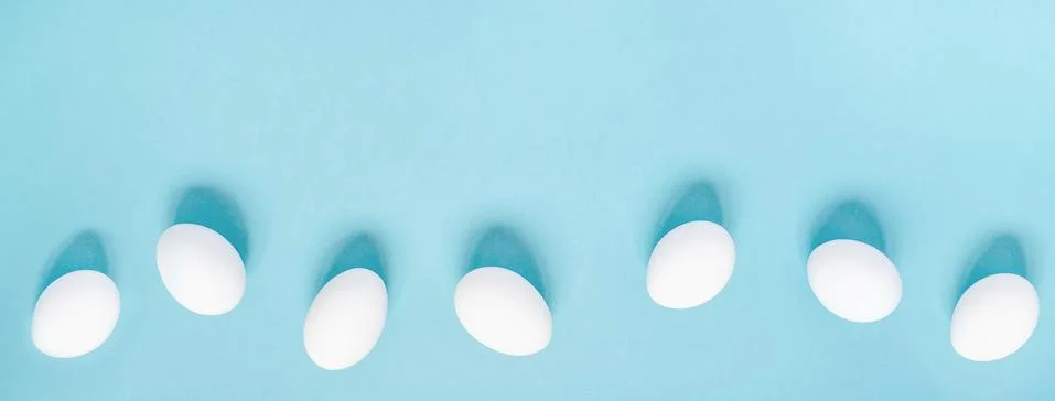 Flat lay composition of creative Easter bunny ears on blue background, space  写真素材