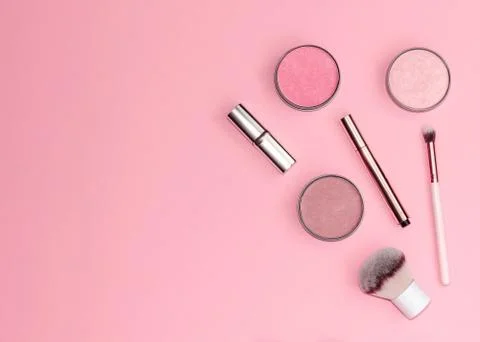 Flat lay composition with decorative makeup products on pastel pink background. Stock Photos