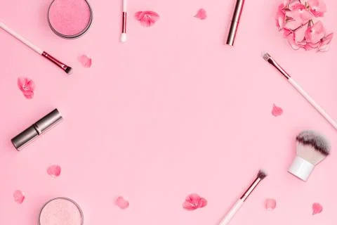 Flat lay composition with decorative makeup products and pink flowers on pastel Stock Photos