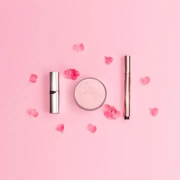 Flat lay composition with decorative makeup products and pink flowers on past Stock Photos