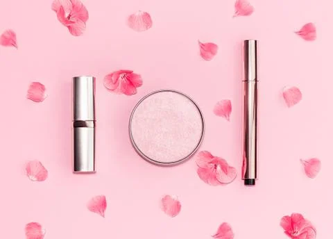 Flat lay composition with decorative makeup products and pink flowers on pastel Stock Photos