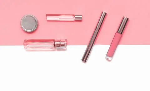 Flat lay composition with decorative makeup products and parfume on coral and Stock Photos