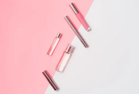 Flat lay composition with decorative makeup products and parfume on coral and Stock Photos