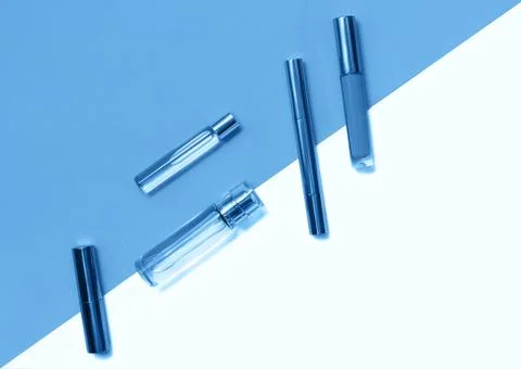 Flat lay composition with decorative makeup products and parfume on trendy blue Stock Photos