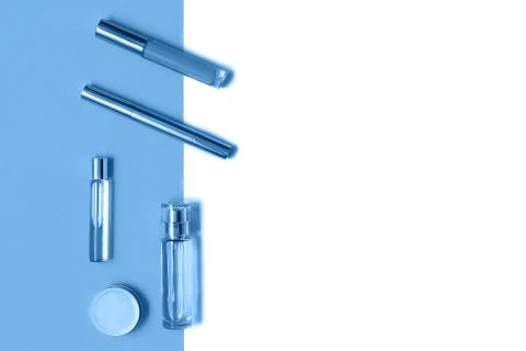 Flat lay composition with decorative makeup products and parfume on trendy blue Stock Photos