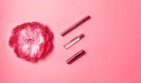 Flat lay composition with decorative makeup products, perfume and peony on pink Stock Photos
