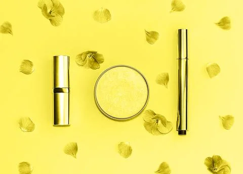 Flat lay composition with decorative makeup products and flowers toned in tre Stock Photos