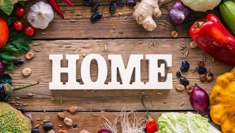 Flat lay composition with decorative word home and vegetables. Stock Photos