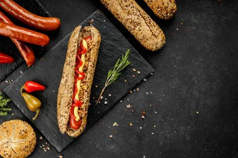 Flat lay composition of delicious hot dogs and sandwiches with different Stock Photos