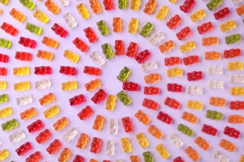 Flat lay composition with delicious jelly bears on color background Foto stock