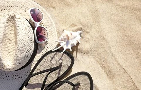 Flat lay composition with different beach accessories on sand. Space for text Stock Photos