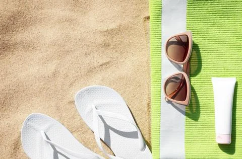 Flat lay composition with different beach accessories on sand. Space for text Stock-Fotos