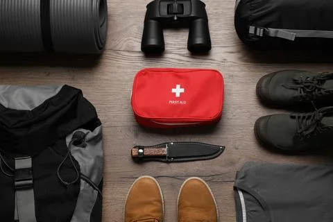Flat lay composition with different camping equipment on wooden background Stock Photos