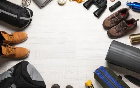 Flat lay composition with different camping equipment on wooden background, s Stock Photos