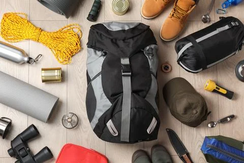 Flat lay composition with different camping equipment on wooden background Stock Photos