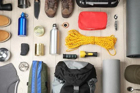 Flat lay composition with different camping equipment on wooden background Stock-Fotos