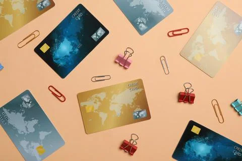 Flat lay composition with different credit cards and paper clips on beige bac Stock Photos