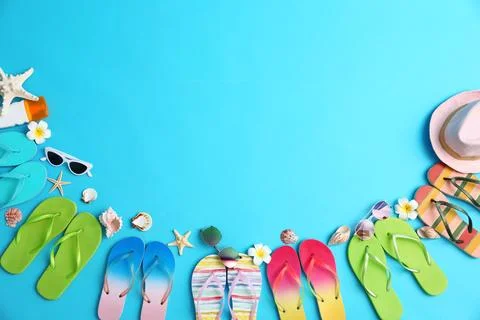 Flat lay composition with different flip flops on blue background, space for  Stock Photos
