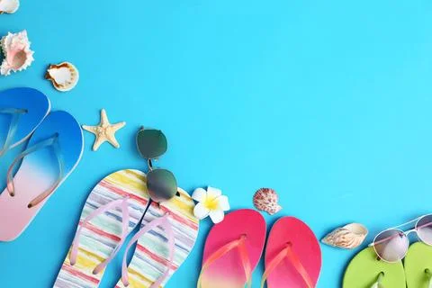 Flat lay composition with different flip flops on blue background, space for  Stock-Fotos