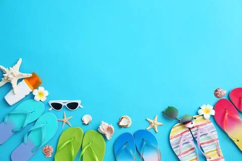 Flat lay composition with different flip flops on blue background, space for  스톡 사진