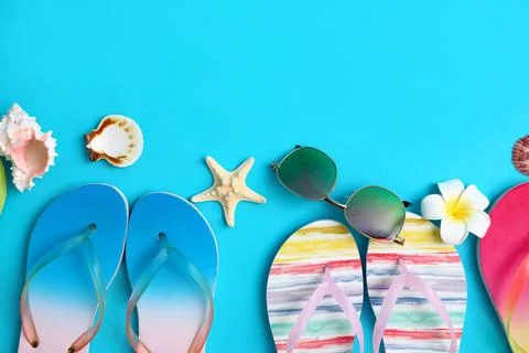 Flat lay composition with different flip flops on blue background, space for  스톡 사진