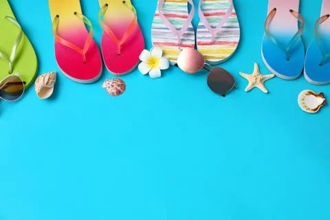 Flat lay composition with different flip flops on blue background, space for  스톡 사진