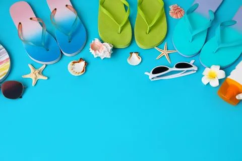 Flat lay composition with different flip flops on blue background, space for  Stock Photos