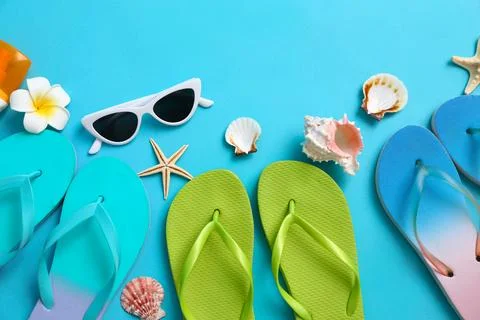 Flat lay composition with different flip flops on blue background, space for  Stock-Fotos