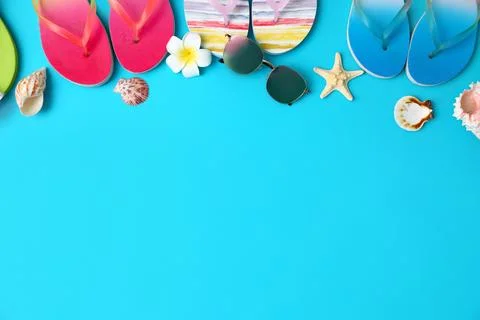Flat lay composition with different flip flops on blue background, space for  Stock-Fotos