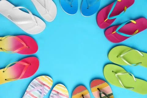 Flat lay composition with different flip flops on blue background, space for  스톡 사진