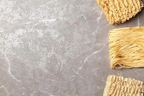Flat lay composition with different quick cooking noodles on color background Stock Photos