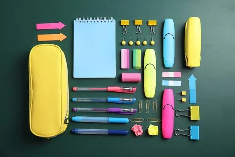 Flat lay composition with different school stationery on chalkboard surface Stock Photos