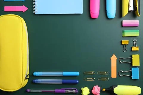 Flat lay composition with different school stationery on chalkboard surface Stock Photos
