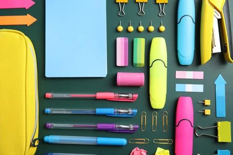 Flat lay composition with different school stationery on chalkboard surface Stock Photos