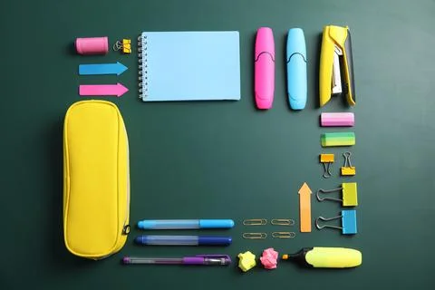 Flat lay composition with different school stationery on chalkboard surface Stock Photos