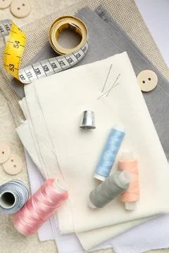 Flat lay composition with different sewing supplies on table Stock Photos