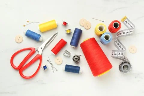 Flat lay composition with different sewing supplies on white table Stock Photos