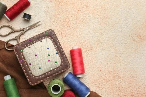 Flat lay composition with different sewing supplies on beige textured table.. Stock Photos