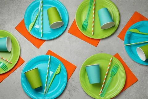 Flat lay composition with disposable tableware on light background Stock Photos