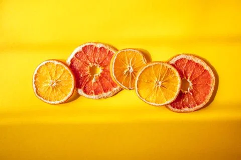 Flat lay composition with dry oranges on orange background and windowlight Stock Photos